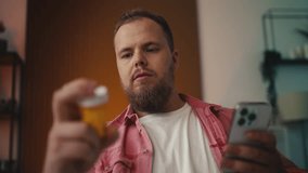 Overweight man holding fat burner supplement, checking side effects on his phone - Powered by Shutterstock - Get 15% off with code: PIKWIZARD15
