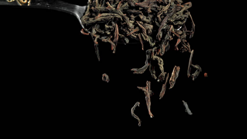 Dry tea falls from a spoon. Filmed on a high-speed camera at 1000 fps. High quality FullHD footage