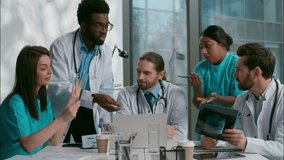 Stressed nervous group of multiethnic diverse doctors men women interns medical students quarreling coworkers confused about diagnosis brainstorming arguing conflict conversation meeting room hospital - Powered by Shutterstock - Get 15% off with code: PIKWIZARD15