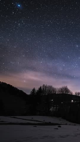 Vertical Timelapse of Starry Night Sky with Milky Way Galaxy to Sunrise Over Winter Forest Nature