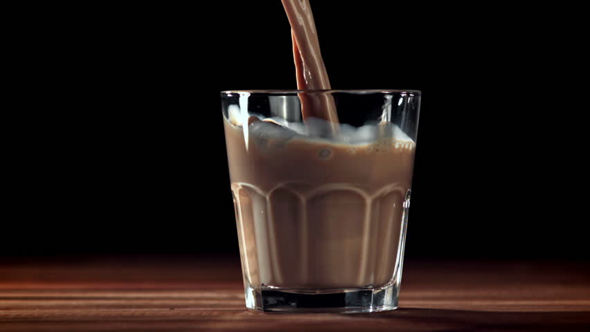 Hot chocolate is poured into a glass. Filmed on a high-speed camera at 1000 fps. High quality FullHD footage