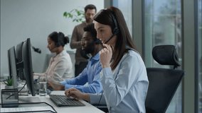 Multiethnic call center operators businesswoman helpline headset typing computer pc African American business man Indian woman working Caucasian businessman checking work tablet explaining callcenter - Powered by Shutterstock - Get 15% off with code: PIKWIZARD15