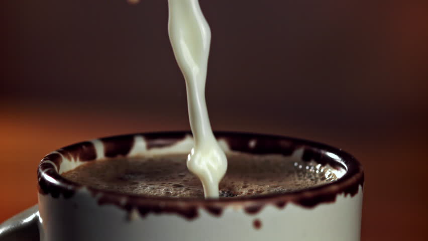 Milk is poured into hot chocolate. Filmed on a high-speed camera at 1000 fps. High quality FullHD footage
