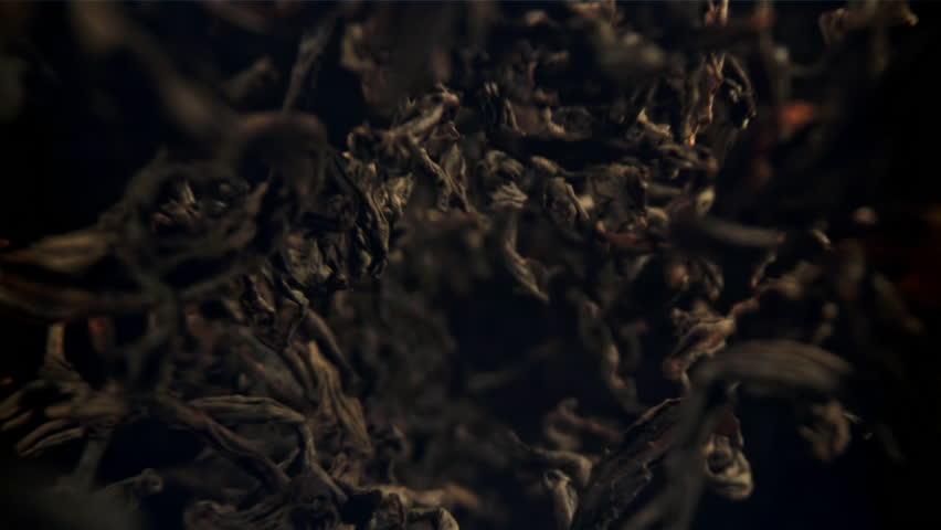 Dry tea leaves fall down. Filmed on a high-speed camera at 1000 fps. High quality FullHD footage