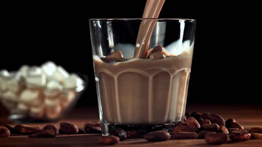Hot chocolate is poured into a glass. Filmed on a high-speed camera at 1000 fps. High quality FullHD footage