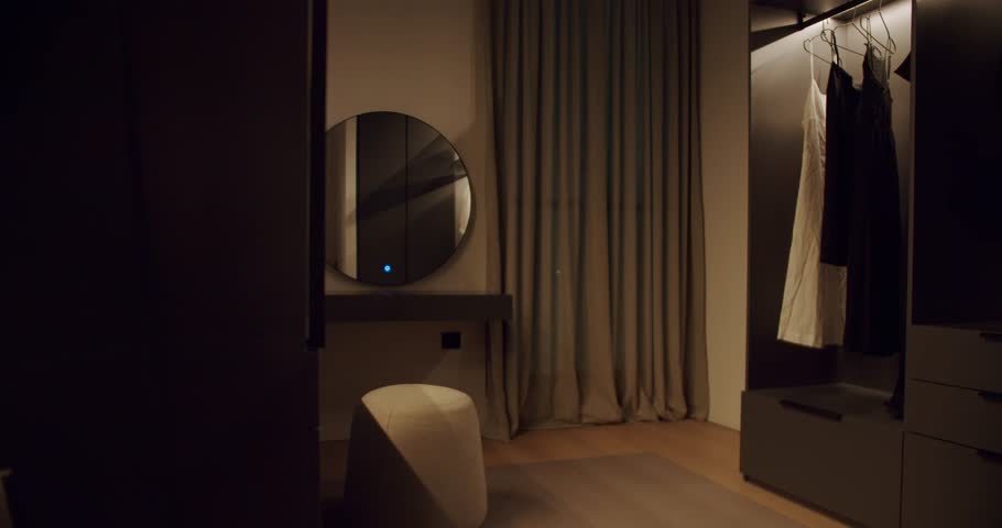 Modern bedroom interior design with wardrobe, mirror, and pouf. Soft, diffused lighting creates a calm, inviting ambiance. Stylish and minimalist decor in neutral tones. home furnishings relaxation.