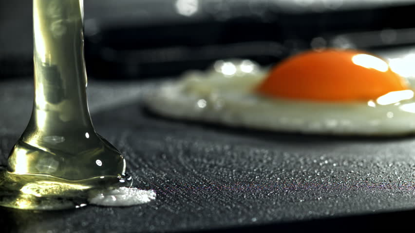 The broken egg falls into the pan. Filmed on a high-speed camera at 1000 fps. High quality FullHD footage