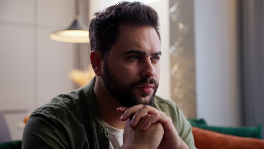Stressed anxious thoughtful Caucasian nervous sad business man male guy homeowner businessman thinking complicated problem question solution think hands in lock gesture sitting couch at home indoors