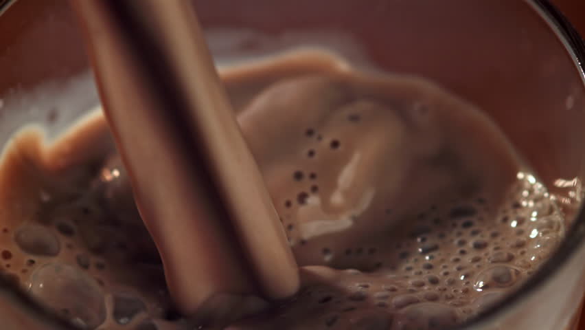 Hot chocolate is poured into a glass. Filmed on a high-speed camera at 1000 fps. High quality FullHD footage