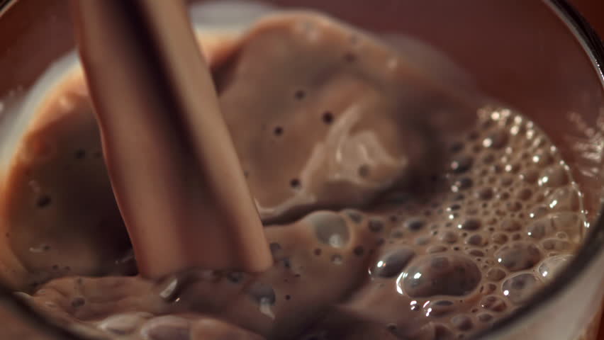 Hot chocolate is poured into a glass. Filmed on a high-speed camera at 1000 fps. High quality FullHD footage