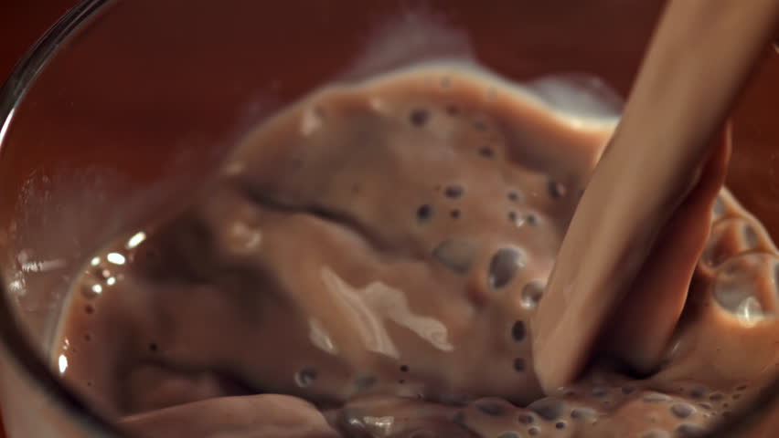 Hot chocolate is poured into a glass. Filmed on a high-speed camera at 1000 fps. High quality FullHD footage