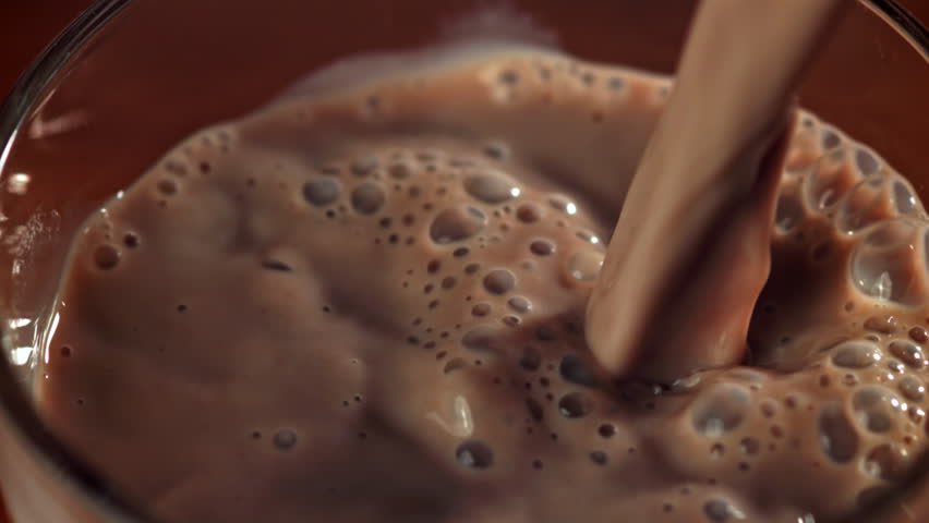 Hot chocolate is poured into a glass. Filmed on a high-speed camera at 1000 fps. High quality FullHD footage