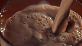 Hot chocolate is poured into a glass. Filmed on a high-speed camera at 1000 fps. High quality FullHD footage - Powered by Shutterstock - Get 15% off with code: PIKWIZARD15