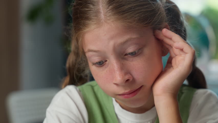 Close up sad face tired child school kid exhausted bored schoolgirl learner pupil lazy sleepy Caucasian little girl student doing hard difficult task reading homework exam indoors classroom education - Powered by Shutterstock - Get 15% off with code: PIKWIZARD15