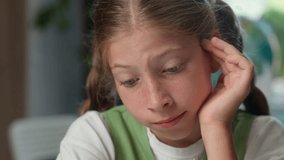 Close up sad face tired child school kid exhausted bored schoolgirl learner pupil lazy sleepy Caucasian little girl student doing hard difficult task reading homework exam indoors classroom education - Powered by Shutterstock - Get 15% off with code: PIKWIZARD15