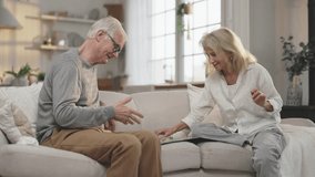 Have fun and joy at home, play board games, happy elderly spouses on sofa. Grandmother and grandfather spending time together and feeling happiness and joy, carefree grey-haired man and woman portrait - Powered by Shutterstock - Get 15% off with code: PIKWIZARD15