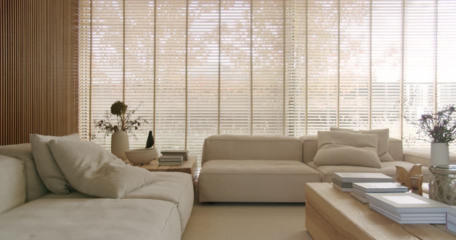Bright, minimalist living room with large windows, wooden blinds, and comfortable sofas. The room is filled with natural light, creating a calming and peaceful atmosphere. home decor, interior design
