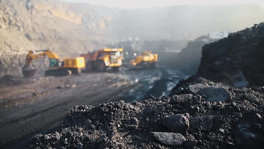 Mining blur background concept. Excavation progress, bulldozers and excavators operate in massive open coal mine