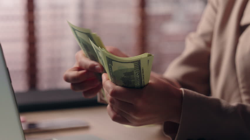 Close up successful smiling happy Caucasian business female hands counting money businesswoman girl entrepreneur employee count income salary prize woman working laptop online gambling victory indoor