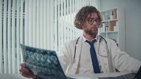 A Doctor Works, Analyzing X-rays and CT Scans on a Computer Screen He Reviews Digital Medical Data to Provide Accurate Diagnoses and Treatment Plans. Concept of Medical Professionalism and Expert Care - Powered by Shutterstock - Get 15% off with code: PIKWIZARD15