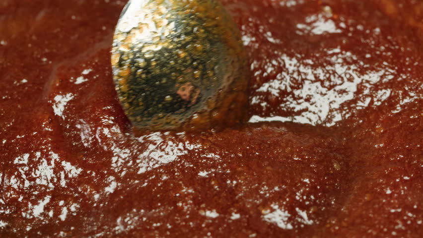 Close up of boiling sugar with bubbles turns into caramel, caramelization, making berry jam at home close-up. Chef cooking dessert in cafe, restaurant pastry food.