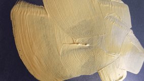 Brushing broad strokes of metallic gold paint on canvas: dynamic movement and texture. - Powered by Shutterstock - Get 15% off with code: PIKWIZARD15