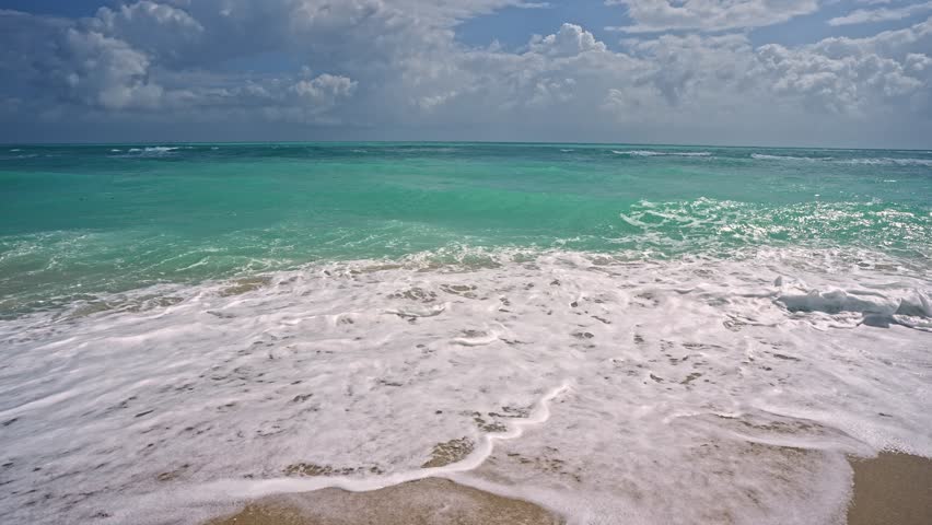 Sea beach sand. Scenic sea beach backdrop. Paradise ocean view. Foamy ocean background. Exotic ocean. Open sea beach horizon. Relaxing waves. Summer background.