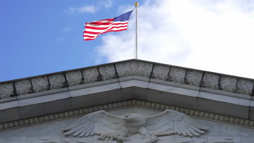 American flag waving in Washington DC. USA symbol. United States flag. Flag against sky in Capitol. Flying American flag. Vote for freedom. Capitol Hill flags