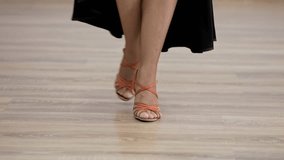Dancer executes precise footwork in orange heels, demonstrating grace and skill in a dance studio, close up - Powered by Shutterstock - Get 15% off with code: PIKWIZARD15