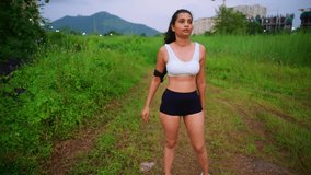 Woman stands still catching breath after tough session, Lady in sports bra pauses along leafy trail, Athletic female with armband halts near hedge path, Exhausted girl breathes heavily, Fitness lover - Powered by Shutterstock - Get 15% off with code: PIKWIZARD15