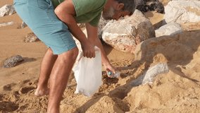 Volunteer collecting plastic waste from the beach during a community cleanup event, promoting environmental awareness and sustainability - Powered by Shutterstock - Get 15% off with code: PIKWIZARD15