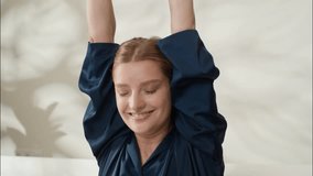 Carefree positive Caucasian girl stretching hands waking up morning cozy at home bedroom smiling adult female lying comfortable bed beauty treatment blanket woman rest weekend beautiful lady napping - Powered by Shutterstock - Get 15% off with code: PIKWIZARD15