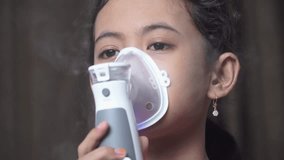 Little girl makes inhalation with a nebulizer. Children's asthma inhaler cough steam inhalation - Powered by Shutterstock - Get 15% off with code: PIKWIZARD15