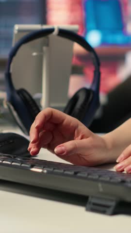 Vertical Video Focused editor woman works on video montage in creative software at agency office, digital media. Filmmaker using dual monitors to edit footage and create content, post production
