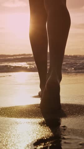 Beautiful Woman Walking on Marine Beach and Wet Legs Shape Moving Close-up. One Adult Girl at Bright Scenic Sea Going Swim or Splash. Modern Romance of Ocean Bathing and Amazing Summer Sky at Sundown