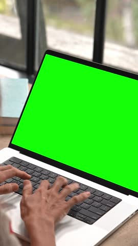 Business Woman Working at Laptop Computer with Green Screen Chroma Key for Mockup. Typing Text on Keyboard or Talking in Internet Messages. Student Studies Homework Content or Speaks Online at Website