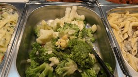 Slow motion. frying pan with cauliflower stands on the stove. the cook places the vegetables with a metal spoon. - Powered by Shutterstock - Get 15% off with code: PIKWIZARD15