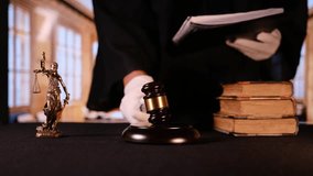 A judge diligently prepares to make an important ruling with a gavel and various legal books in a courtroom setting - Powered by Shutterstock - Get 15% off with code: PIKWIZARD15