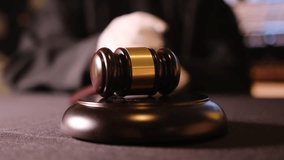 A judge striking a gavel symbolizes crucial decisionmaking and authority within the courtroom setting - Powered by Shutterstock - Get 15% off with code: PIKWIZARD15