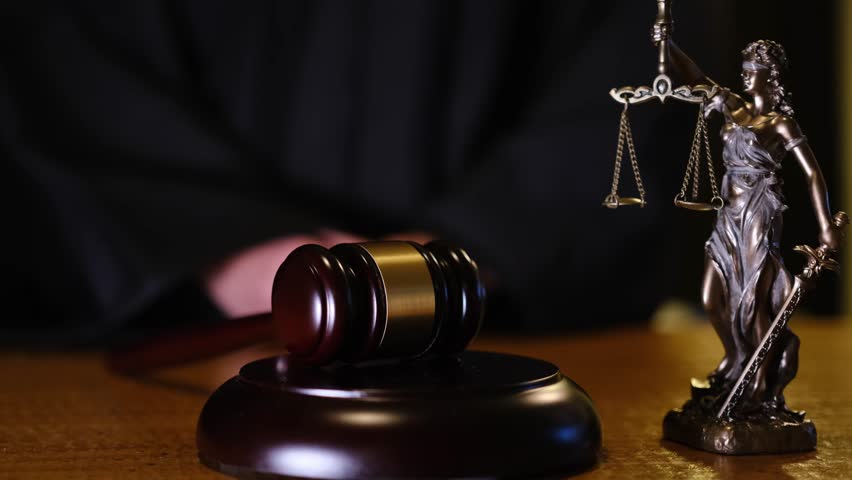 A gavel alongside a Lady Justice statue beautifully exemplifies the legal process found within a courtroom setting