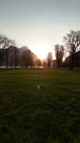 Sunset golden sky Walensee lake water sun reflection aerial drone Switzerland