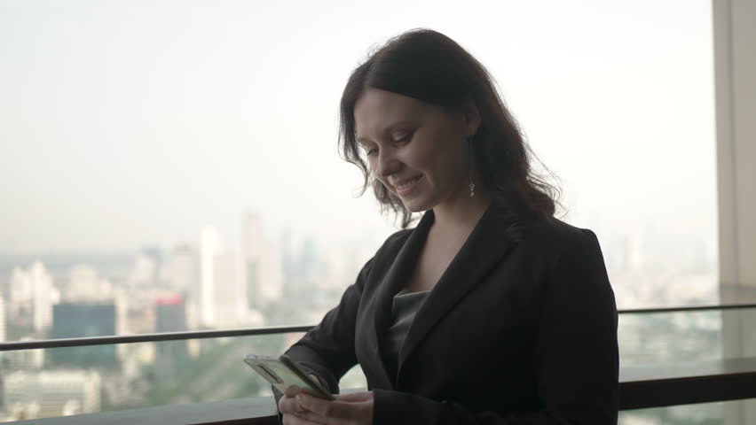 White collar worker is using smart phone at skyscraper. Business, technology, formalwear.