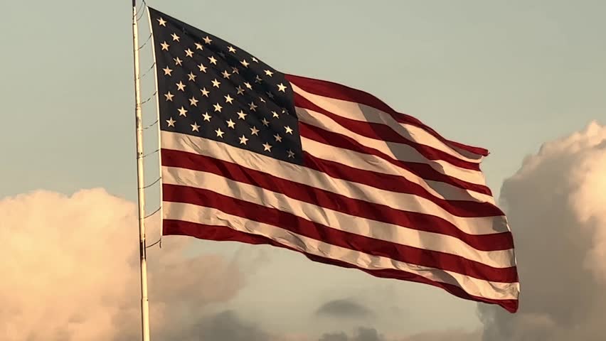 United States of America flag waving with stars and stripes blowing in the wind, representing liberty, strength and national pride.