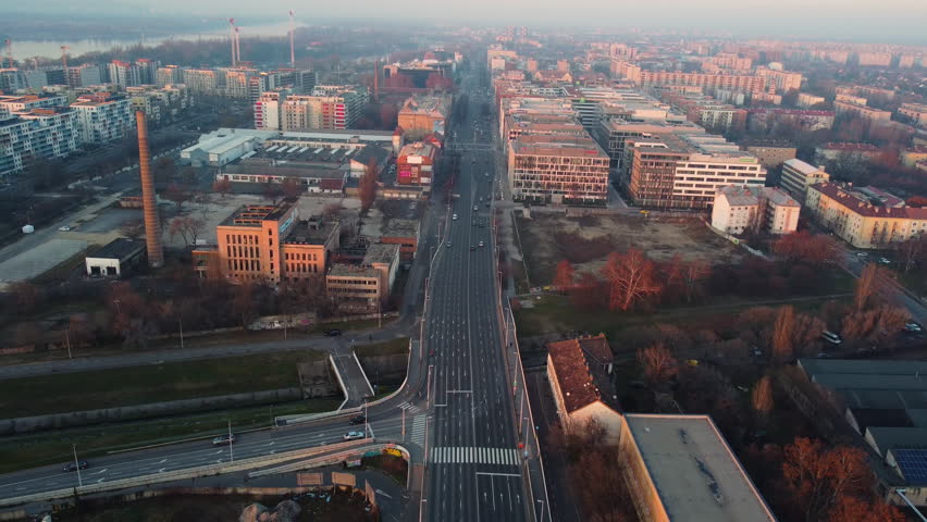 Central Budapest viewed from high altitude with defined roads, traffic, and sunrise glow