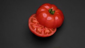 4K video of tomato cut in half and turned on black background.
Repeat playback available. - Powered by Shutterstock - Get 15% off with code: PIKWIZARD15