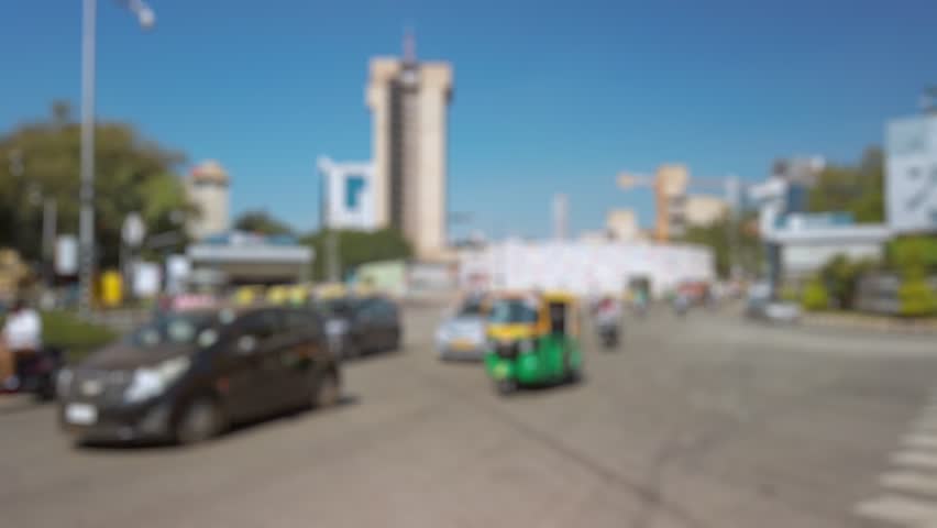Bokeh view of road traffic on the streets of Bangalore, India. Blurred background footage.