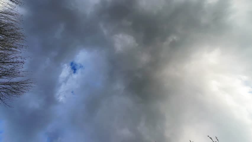 Enjoy the mesmerizing dance of clouds in this timelapse video, showcasing shades of gray and blue, ideal for nature lovers and enhancing various video projects with serene visuals