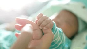 Small Newborn baby holding mother's finger. Motherhood concept. baby's hand has firm grip on the parent's finger. An infant gripping mother finger. - Powered by Shutterstock - Get 15% off with code: PIKWIZARD15