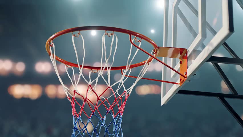 ball goes in basket in arena. a basketball player performing the slam dunk. Basketball going through basketball hoop with net in arena. Sport Concept.
