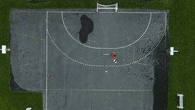 playing basketball game in outdoor court on summer daylight, top aerial view. Aerial shot of men playing basketball on an outdoor basketball court. - Powered by Shutterstock - Get 15% off with code: PIKWIZARD15